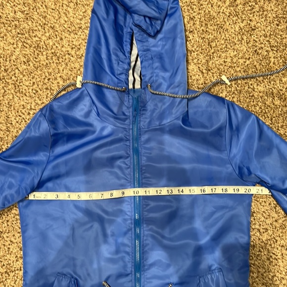 Rain jacket - blue.  Never worn.  Size M runs SMALL.  Drawstring waist and hood - Picture 6 of 7